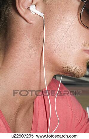 Stock Photography - Young man with MP3 ear buds. Fotosearch