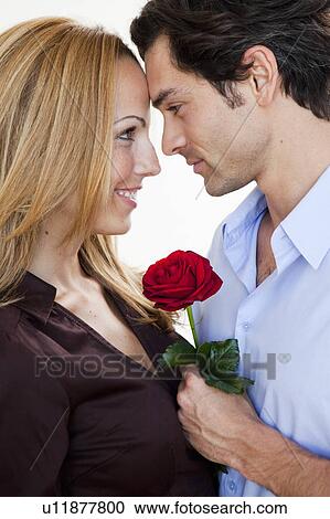 young romantic couple with rose View Large Photo Image Stock Image - young romantic couple with rose. Fotosearch