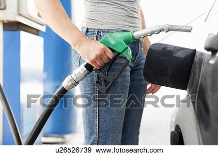 Stock Photo - Young Woman at Gas Station. Fotosearch