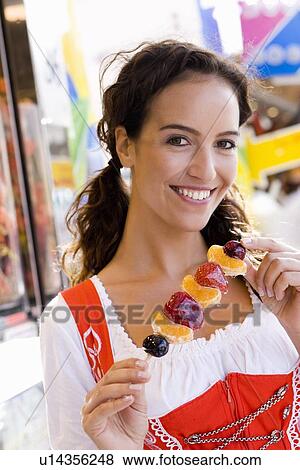 Young Woman Eating Candied Fruits View Large Photo Image Stock Photo - Young Woman Eating Candied Fruits. Fotosearch