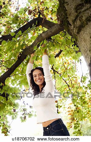 young woman hanging on tree View Large Photo Image Stock Image - young woman hanging on tree. Fotosearch