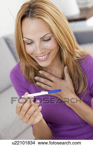 young woman holding pregnancy test View Large Photo Image Picture - young woman holding pregnancy test. Fotosearch