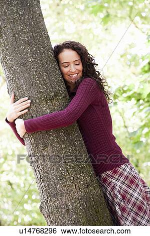 young woman hugging tree View Large Photo Image Stock Photograph - young woman hugging tree. Fotosearch