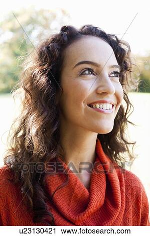 young woman looking at the sky View Large Photo Image Stock Image - young woman looking at the sky. Fotosearch
