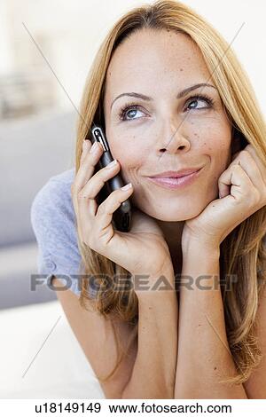 Stock Photo - young woman on cellphone. Fotosearch