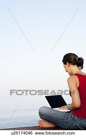 Young Woman On Jetty Looking At Laptop View Large Photo Image Stock Photograph - Young Woman On Jetty Looking At Laptop. Fotosearch