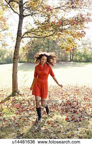 young woman running in meadow View Large Photo Image Stock Photograph - young woman running in meadow. Fotosearch