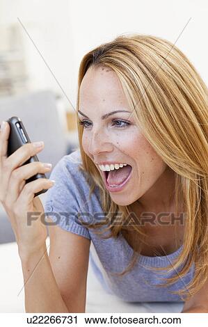 young woman screaming into cell phone View Large Photo Image Stock Image - young woman screaming into cell phone. Fotosearch