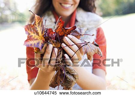 young woman showing leaves View Large Photo Image Stock Photography - young woman showing leaves. Fotosearch