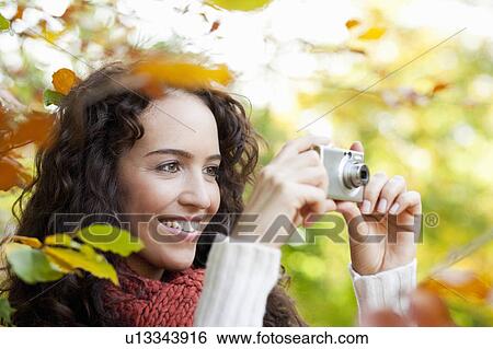 young woman taking photo View Large Photo Image Stock Photograph - young woman taking photo. Fotosearch