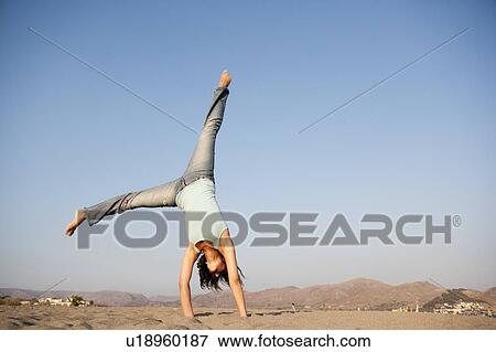Stock Photo - Young Woman Turning Wheels. Fotosearch