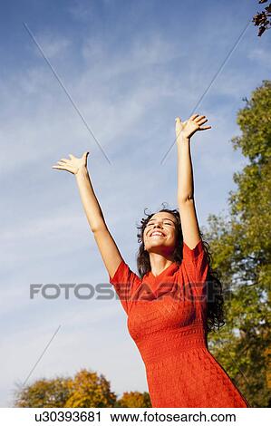 young woman under blue sky View Large Photo Image Stock Image - young woman under blue sky. Fotosearch