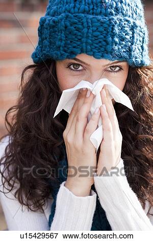 young woman wiping nose View Large Photo Image Stock Photo - young woman wiping nose. Fotosearch