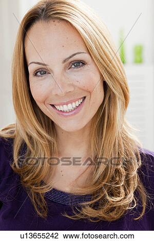 Stock Image - young woman with blond hair smiling. Fotosearch