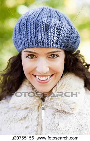 Stock Photograph - young woman with cap portrait. Fotosearch