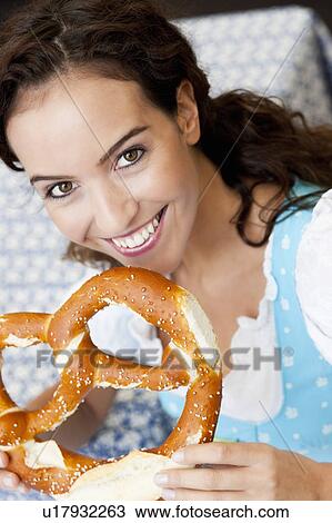 Stock Image - Young Woman With Huge Pretzel. Fotosearch
