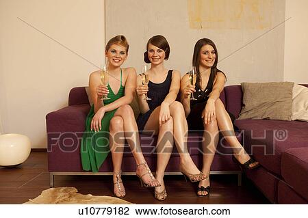 Stock Image - Young women drinking champagne. Fotosearch