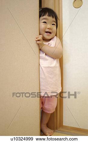 Baby girl peeking over fusuma View Large Photo Image Stock Photo - Baby girl peeking over fusuma. Fotosearch