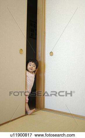 Stock Photo - Baby girl peeking over fusuma. Fotosearch