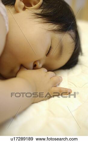 Baby girl sucking thumb, sleeping View Large Photo Image Stock Photo - Baby girl sucking thumb, sleeping. Fotosearch