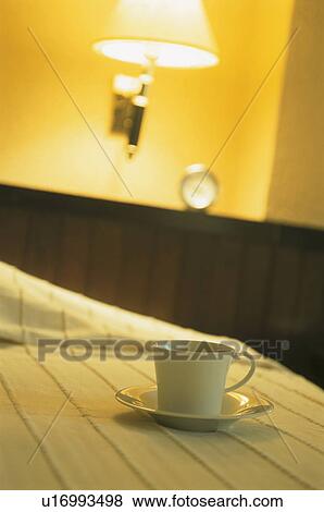 Stock Photo - Bed, clock and coffee. Fotosearch