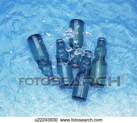Stock Image - Bottles of soda in water. Fotosearch