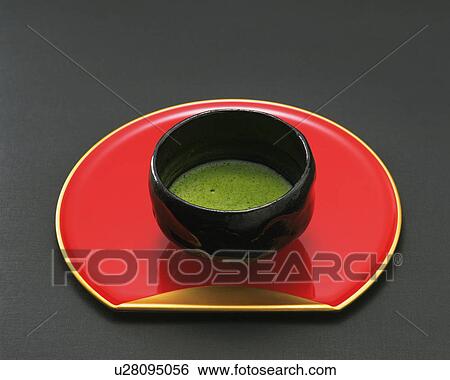 Bowl of green tea on tray, black background View Large Photo Image Stock Photograph - Bowl of green tea on tray, black background. Fotosearch