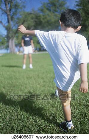 Stock Photo - Boy kicking a soccer ball. Fotosearch