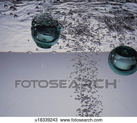 Stock Image - Bubbles in water, white background. Fotosearch