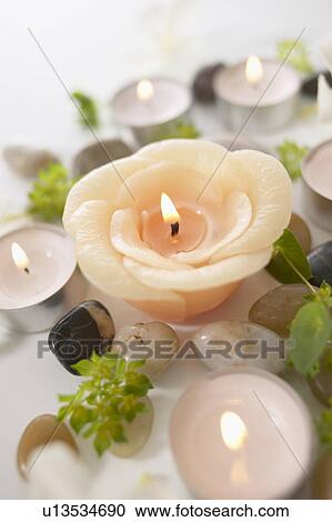 Burning candles and stones, close up, white background View Large Photo Image Stock Image - Burning candles and stones, close up, white background. Fotosearch