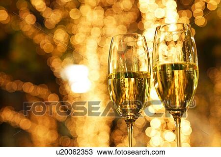 Stock Image - Champagne in front of Christmas illumination. Fotosearch