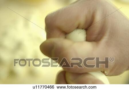 Stock Photograph - Chef holding dough, making dim sum, close up, blurred motion. Fotosearch