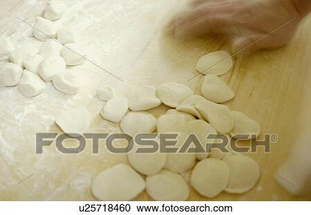 Stock Image - Chef making dim sum, blurred motion. Fotosearch