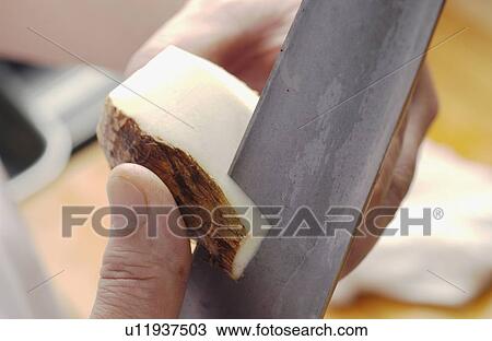 Stock Image - Chef peeling aroid, close up. Fotosearch