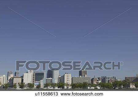Stock Image - Cityscape under blue sky, copy space, Tokyo prefecture, Japan. Fotosearch