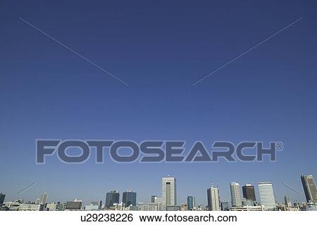 Stock Photograph - Cityscape under blue sky, copy space, Tokyo prefecture, Japan. Fotosearch