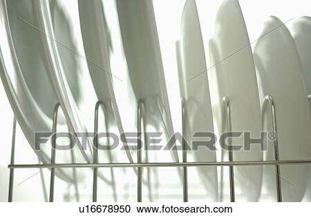 Clean plates on dish rack, close up, white background View Large Photo Image Stock Image - Clean plates on dish rack, close up, white background. Fotosearch