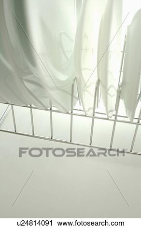 Clean plates on dish rack, close up, white background View Large Photo Image Stock Image - Clean plates on dish rack, close up, white background. Fotosearch