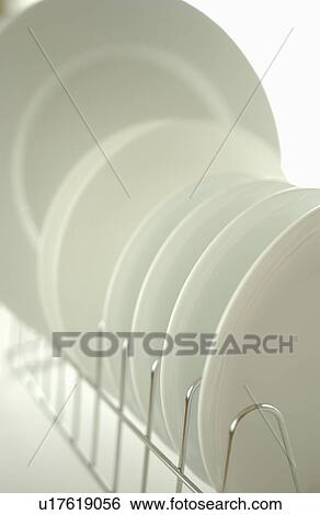 Clean plates on dish rack, close up, white background View Large Photo Image Stock Photograph - Clean plates on dish rack, close up, white background. Fotosearch