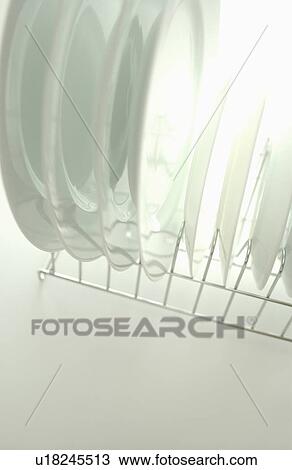 Clean plates on dish rack, white background View Large Photo Image Stock Image - Clean plates on dish rack, white background. Fotosearch