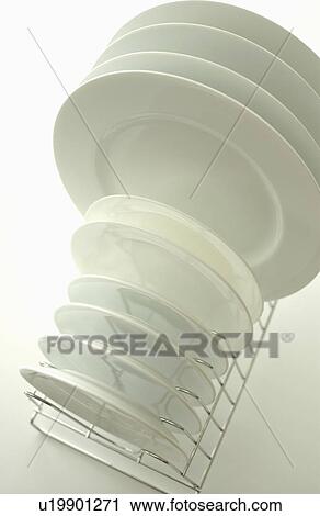 Clean plates on dish rack, white background View Large Photo Image Stock Image - Clean plates on dish rack, white background. Fotosearch