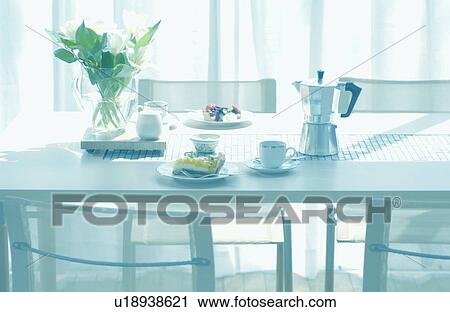 Stock Image - Coffee cup, tart on table. Fotosearch