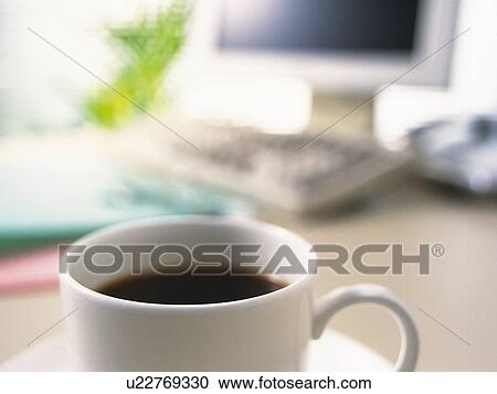 Cup of coffee on desk, close up View Large Photo Image Stock Image - Cup of coffee on desk, close up. Fotosearch