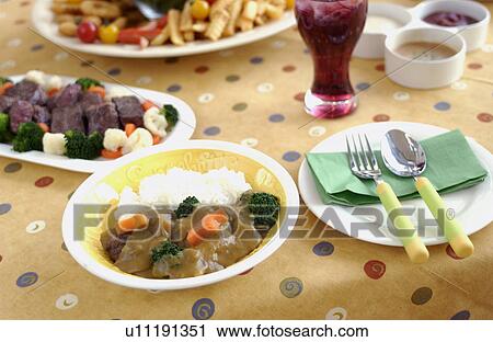 Stock Image - Curry rice and cubed beef for party. Fotosearch