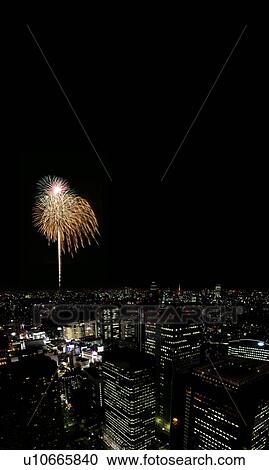 Stock Image - Fireworks over city skyline, Tokyo Prefecture, Honshu, Japan. Fotosearch