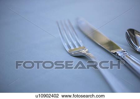 Fork, table knife and spoon on table, close up, white background View Large Photo Image Stock Image - Fork, table knife and spoon on table, close up, white background. Fotosearch