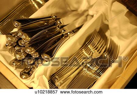 Stock Photo - Forks and table knives in box, close up. Fotosearch