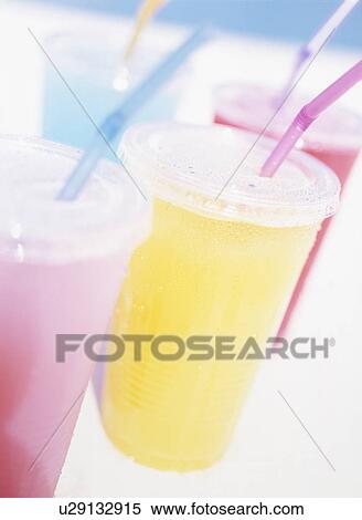 Stock Photography - Fruits juice in cups, close up, white background. Fotosearch