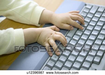 Girl using computer, touching keyboard View Large Photo Image Stock Photo - Girl using computer, touching keyboard. Fotosearch