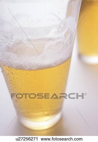 Stock Image - Glass of beer, close up, white background. Fotosearch